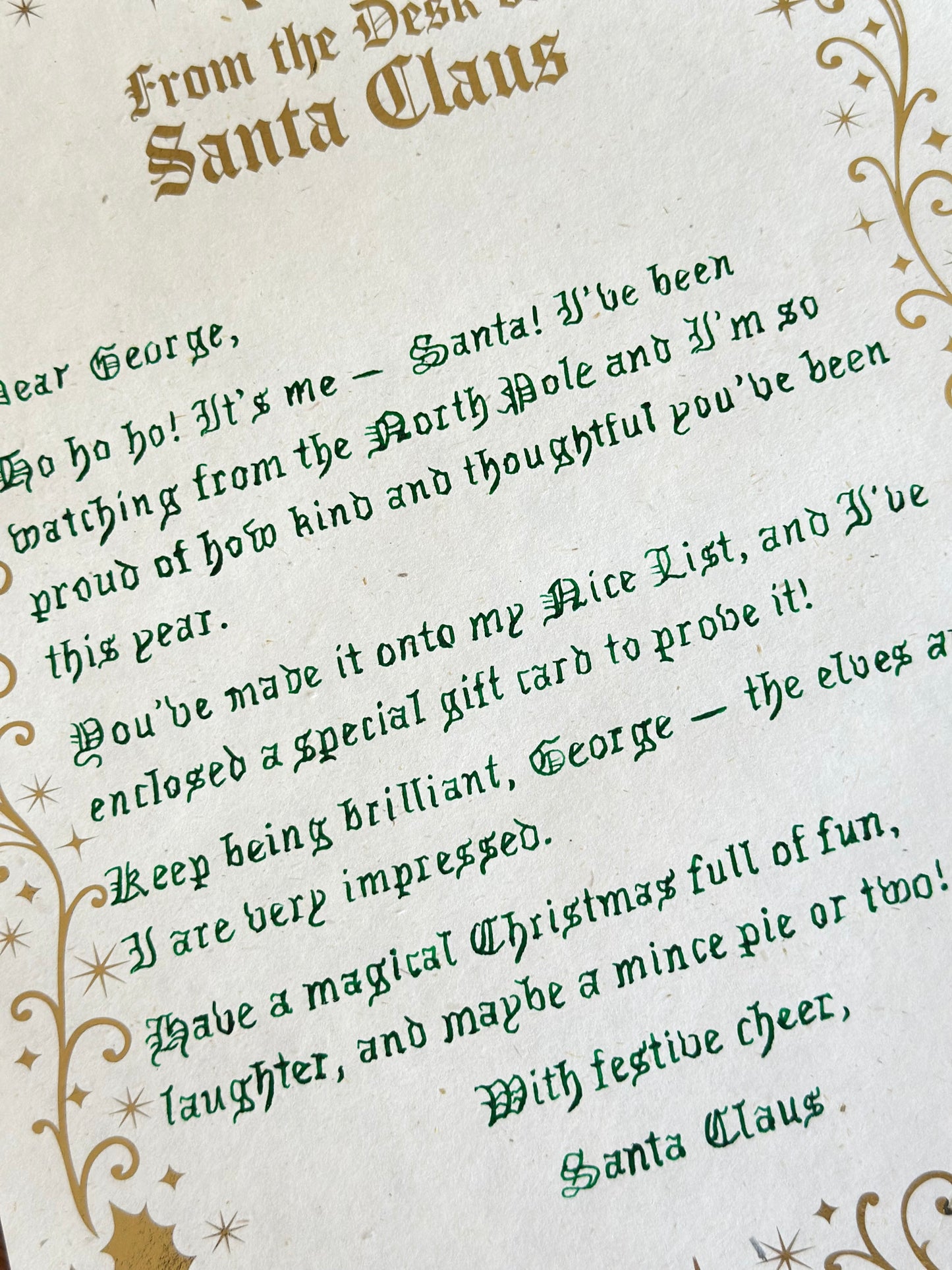 Letter from Santa Claus with decorative text and gold accents on a white background