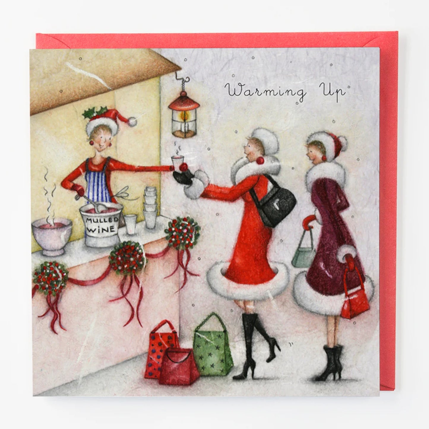 Christmas card with people by a mulled wine stand, featuring text 'Warming Up'.