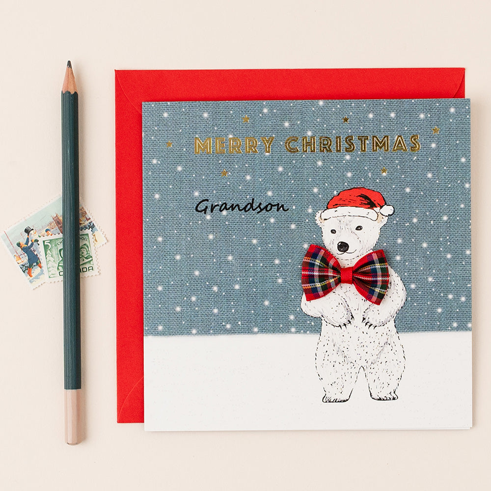 Grandson Christmas card with a polar bear illustration, red envelope, and pencil on a light background