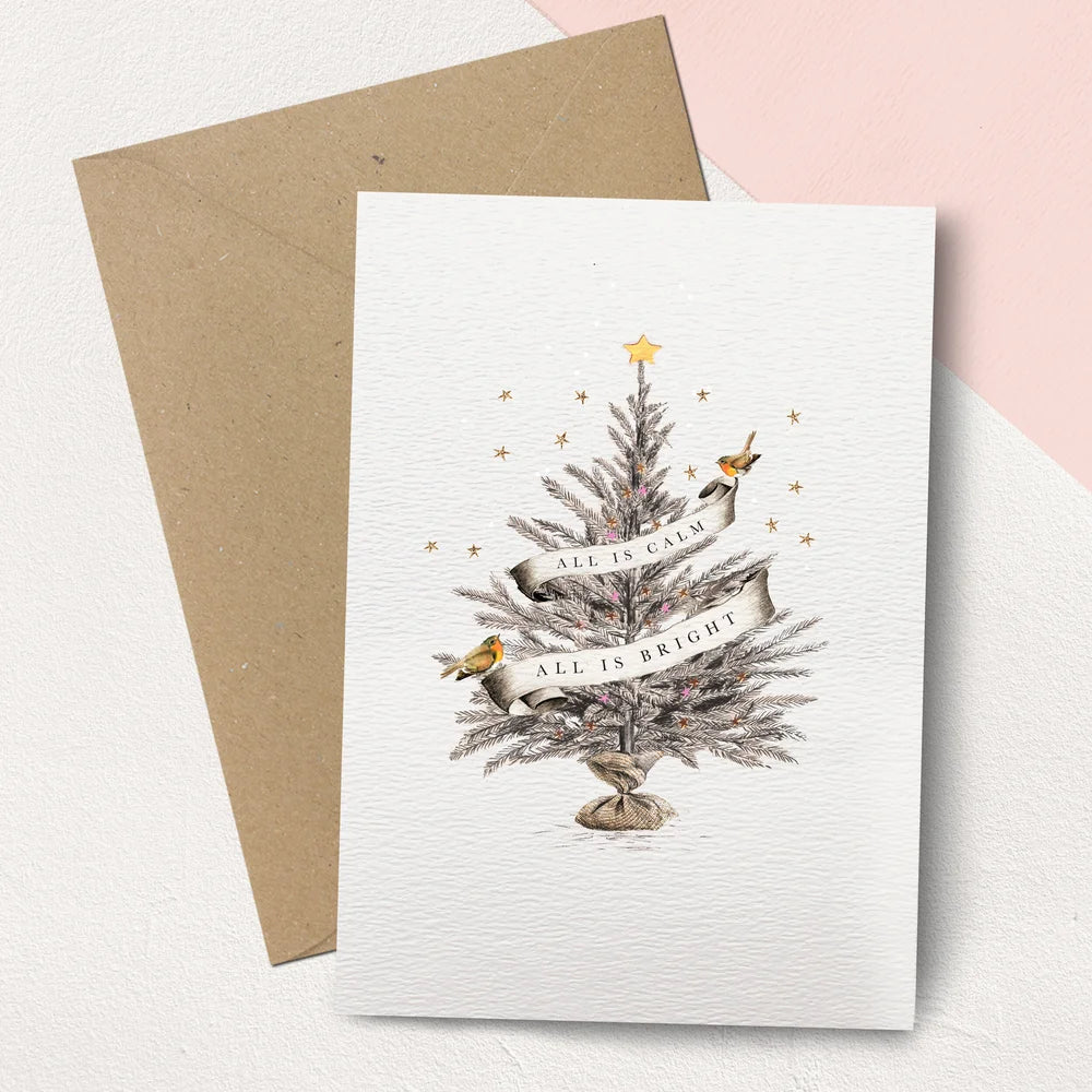 Greeting card with Christmas tree design and envelope on a light background