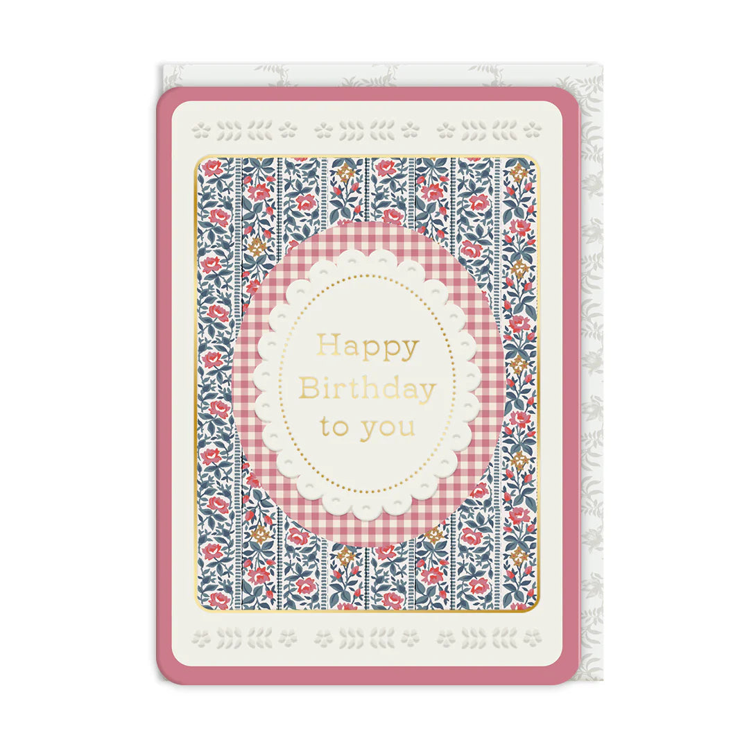 Birthday card with floral and checkered design on a white background