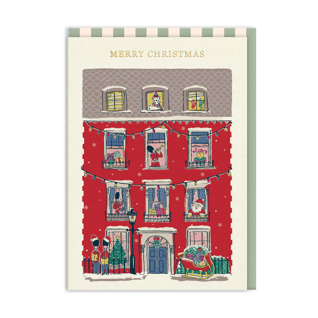 Christmas card with a festive street scene and 'Merry Christmas' text.