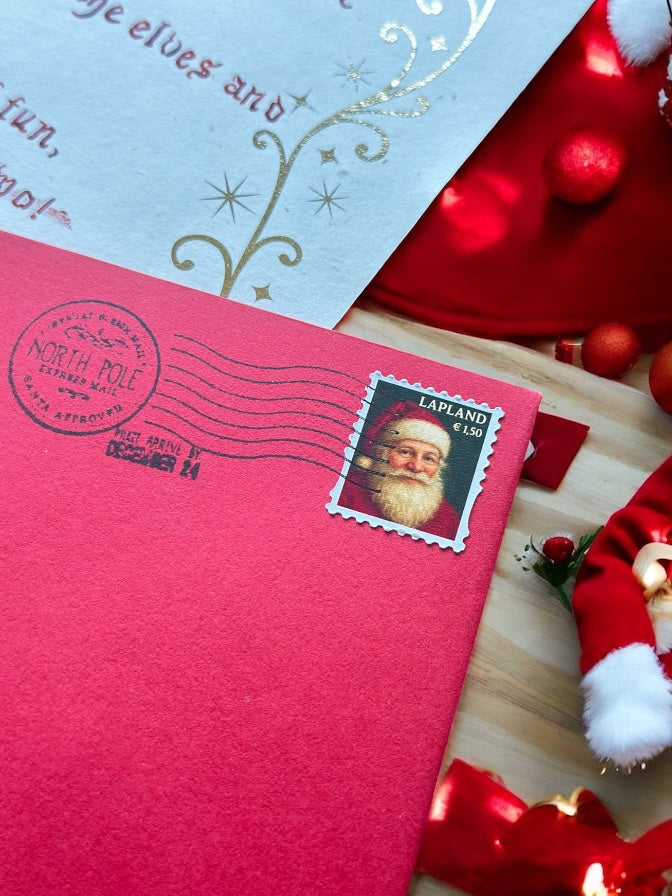 Red envelope with Santa Claus stamp from Lapland on a wooden surface northpole stamp