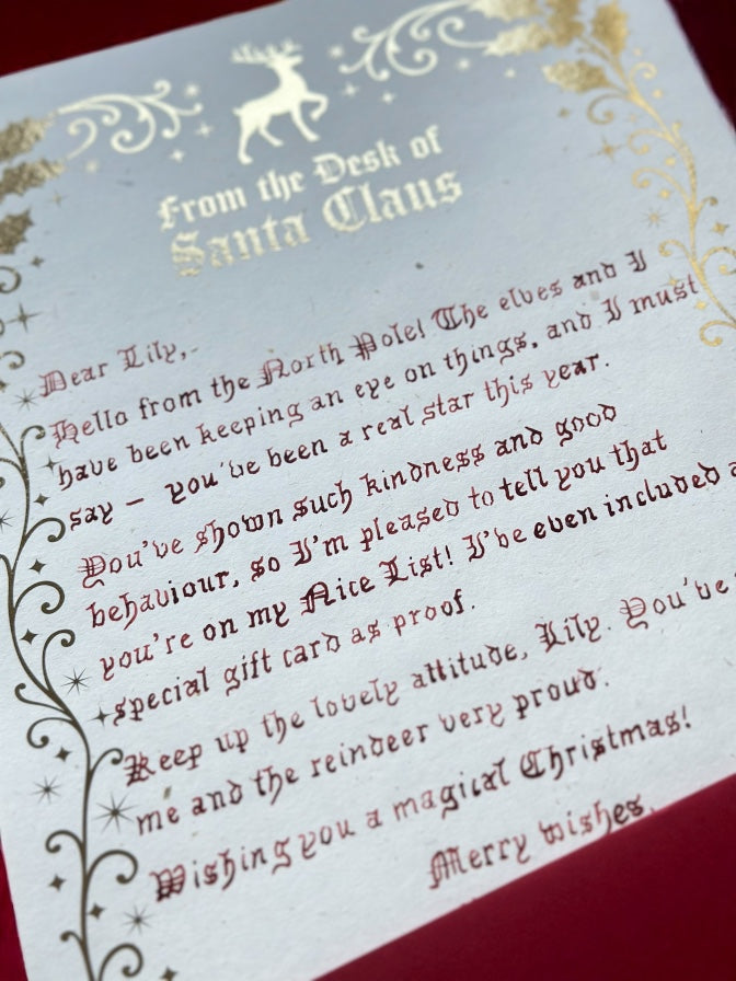 Luxury handwritten Santa letter with gold foil detail and festive holly border from Father Christmas.