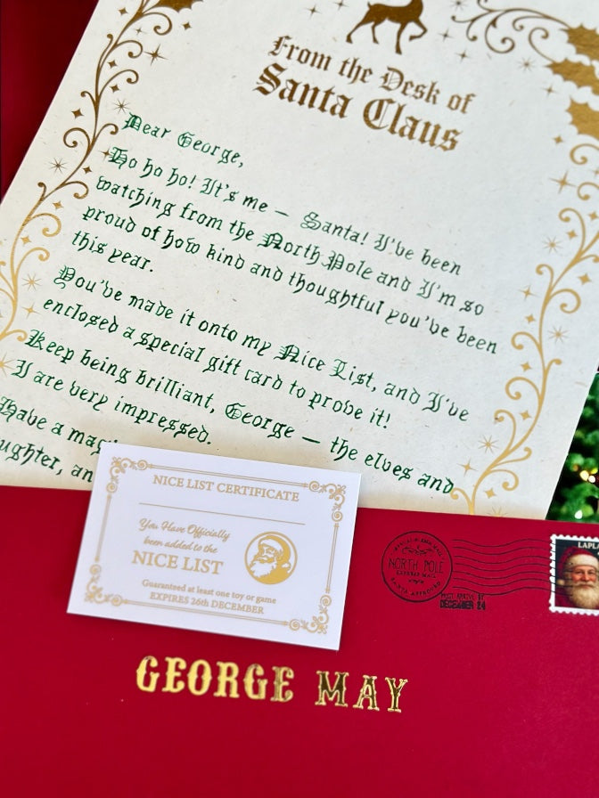 Letter from Santa Claus on a red envelope with a certificate attached, featuring decorative elements.