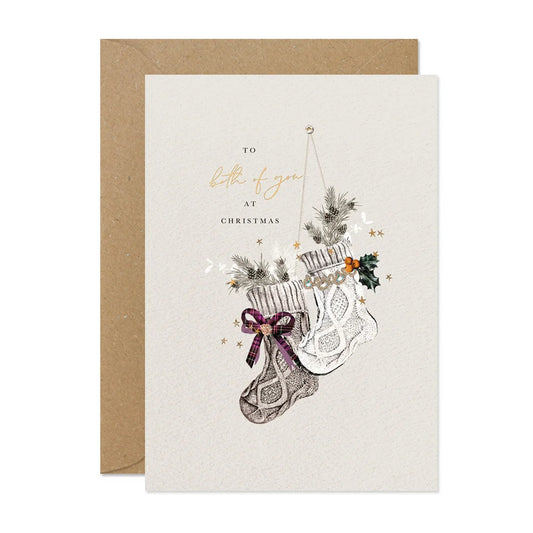 Christmas card with stockings and holly design on a white background