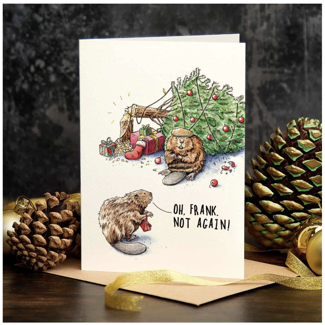 Christmas card with beaver illustration and text 'Oh, Frank not again!' surrounded by pinecones and a gold bow.